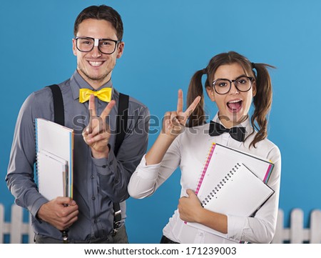 Nerdy students with notebook have fun
