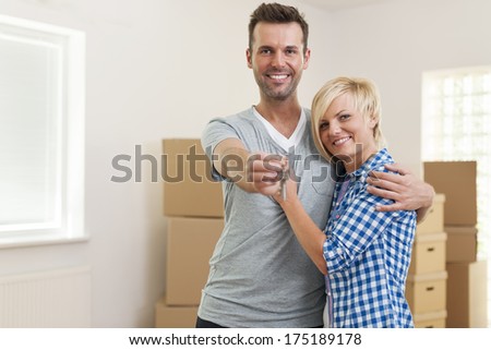 Happy couple in love with key to new home