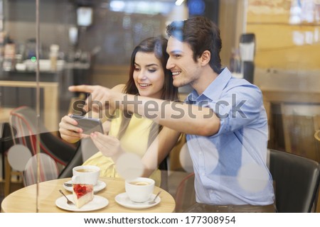 Man showing his girlfriend searched place