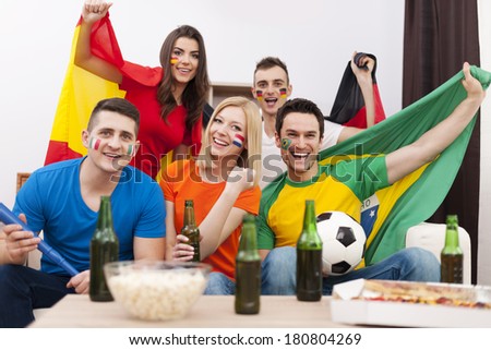 Group of multi national football fans cheering