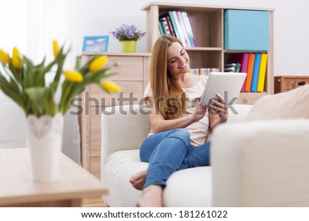 Attractive woman using digital tablet on sofa
