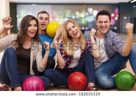 Portrait of smiling friends at the bowling alley