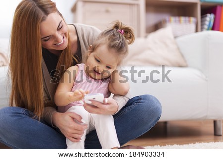 Happy family with contemporary mobile phone at home