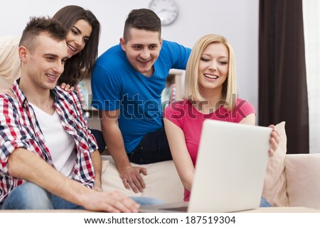 Roommate using laptop in living room