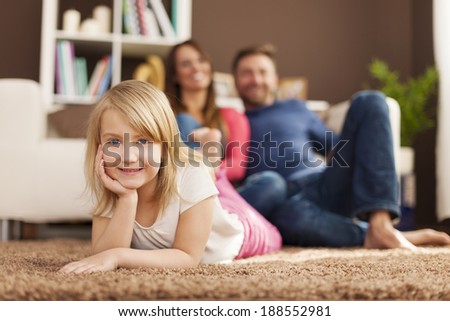 Portrait of smiling girl relaxing with her parents at home