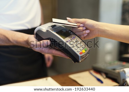 Close up of customer paying by credit card Close up of customer paying by credit card