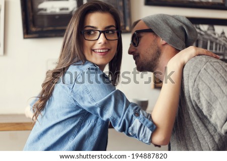 Hipster couple flirting at cafe