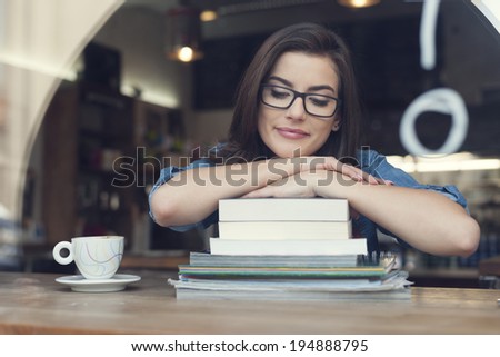 Beautiful and smiling female student at cafe