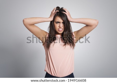 Portrait of angry woman with hand on head