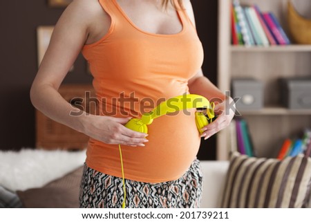 Close up of music therapy for baby in abdomen