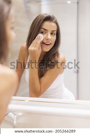 Woman removing makeup from her face