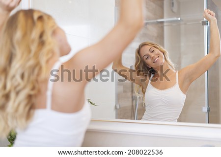 Blonde happy woman stretching in morning