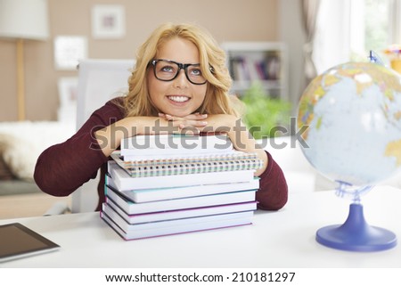 Dreaming blonde female student with books
