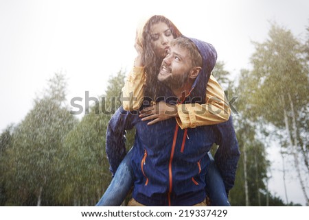 Happy time for loving couple in rain