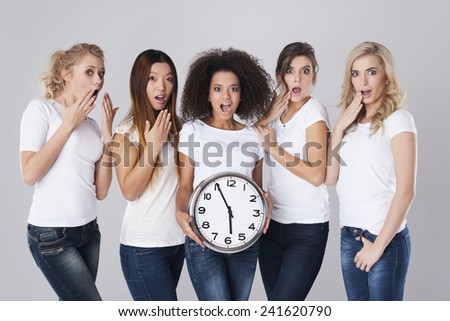 Multi ethnic shocked women with clock