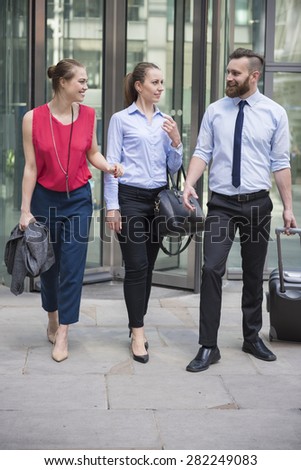 Group of business people leaving office building