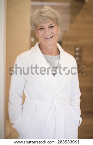 Smiling senior woman in the bathrobe