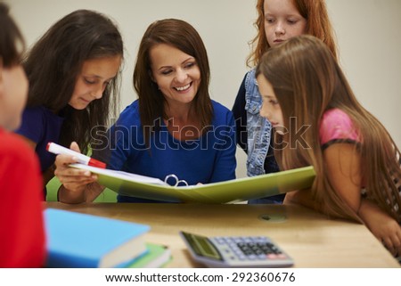 Teacher showing students interesting book