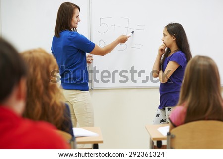 Teacher asking student next to the whiteboard