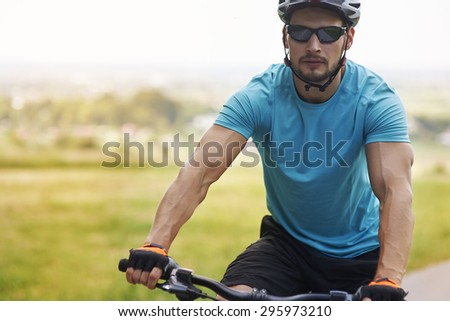 Well built man riding a bike