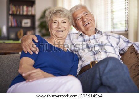 Happy mature couple sitting on the sofa