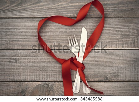 Heart shape ribbon and kitchen silverware
