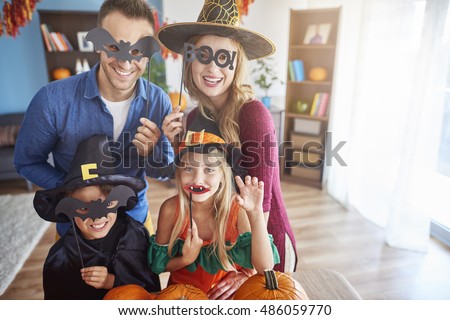 Family wearing funny halloween masks