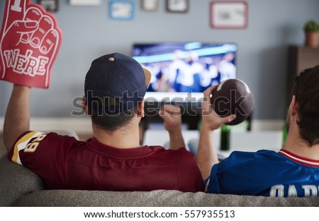 Two men with foam hand and baseball equipment