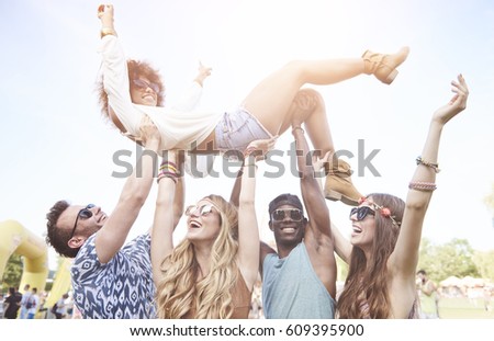 Excited woman crowd surfing at music festival