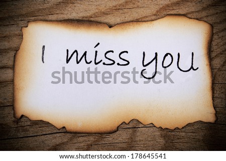 Old paper sheet over wooden background message I miss you