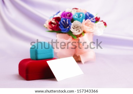Basket with paper flowers, velvet boxes and blank card