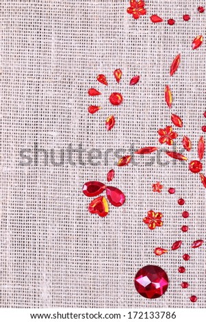 red sequins floral ornament on the linen cloth texture