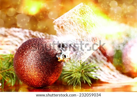 Golden glitter christmas ball on abstract background, selective focus