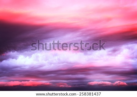Dramatic pink clouds on sunset sky as background