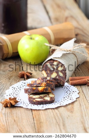 chocolate sausage with decorations on a wooden table