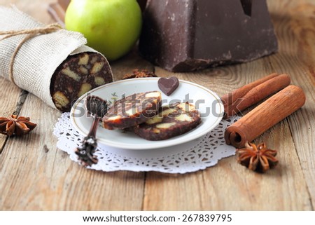 chocolate sausage with decorations on a wooden table