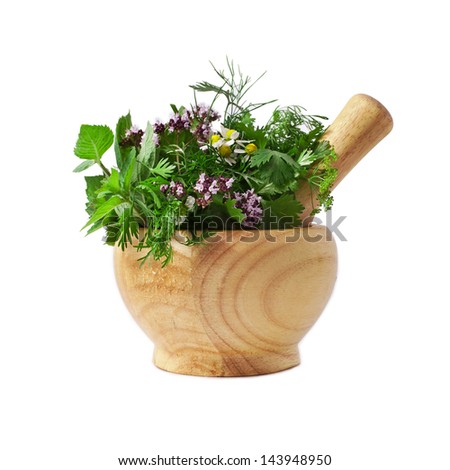 Mortar with fresh herbs isolated on white background