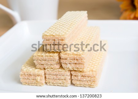 Wafers in white dish and coffee