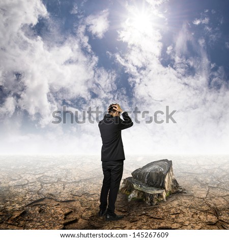 men in suit stand unhappy on cracked ground look stump