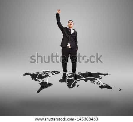 Businessman stand happy on  business plan in digital world map