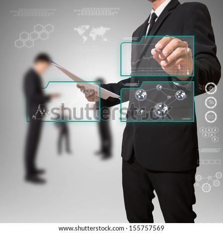 businessman pointing on high technology screen with graph