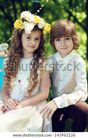 brother and sister twins, sit, flowers in her hair