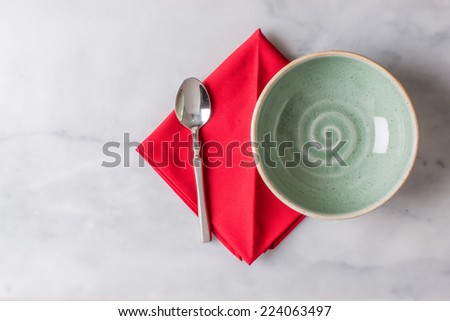 Silver spoon, White Bowls and Red Napkin on marble background
