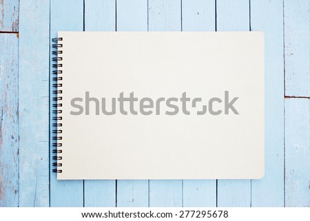 Notebook on blue wood table