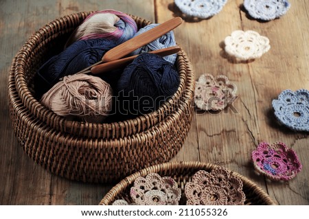 Box of yarn and handmade crocheted flowers
