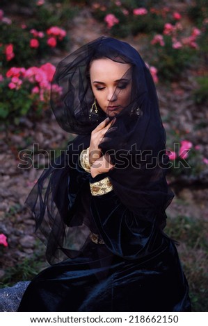 Young widow with closed eyes wearing black veil