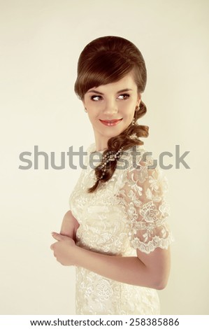 Beautiful young bride with retro hairstyle smiling happily. Retro look.