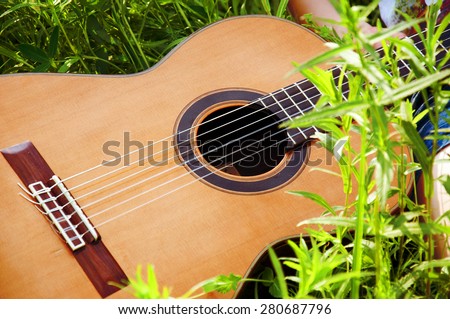 Guitar on the grass. Picnic with friends in summer afternoon.
