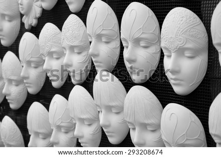 Blank plaster faces templates for future painted masks. Black and white photo.