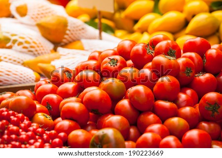 Lot of tomato vegetables and other fruits at a market stall/Tomato Market Sale